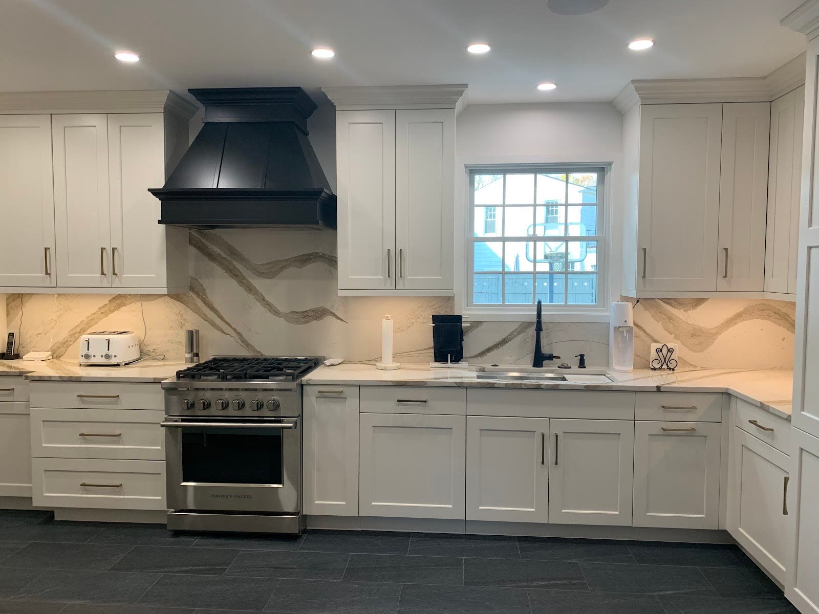 Classic white kitchen with a navy range hood