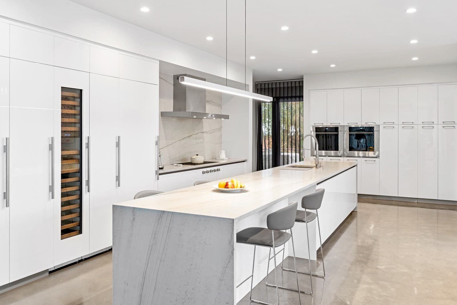 Contemporary white kitchen with waterfall island